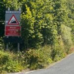 There's a steep climb near Ambleside in NW England's Lake District. It's called The Struggle. This image shows the name and its 20% incline. Another sign reads 'Winter conditions can be hazardous'