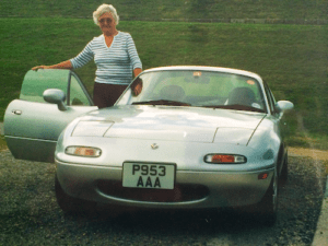 The author's mum stands proudly beside her Mark 1 Mazda MX5.