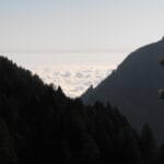 A view looking down on clouds seen from between two peaks. I took this while ascending Mount Olympos.