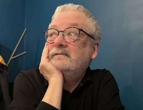 The author in his specs. He's wearing a black shirt. For some reason he's looking up and to the left as authors sometimes do.
